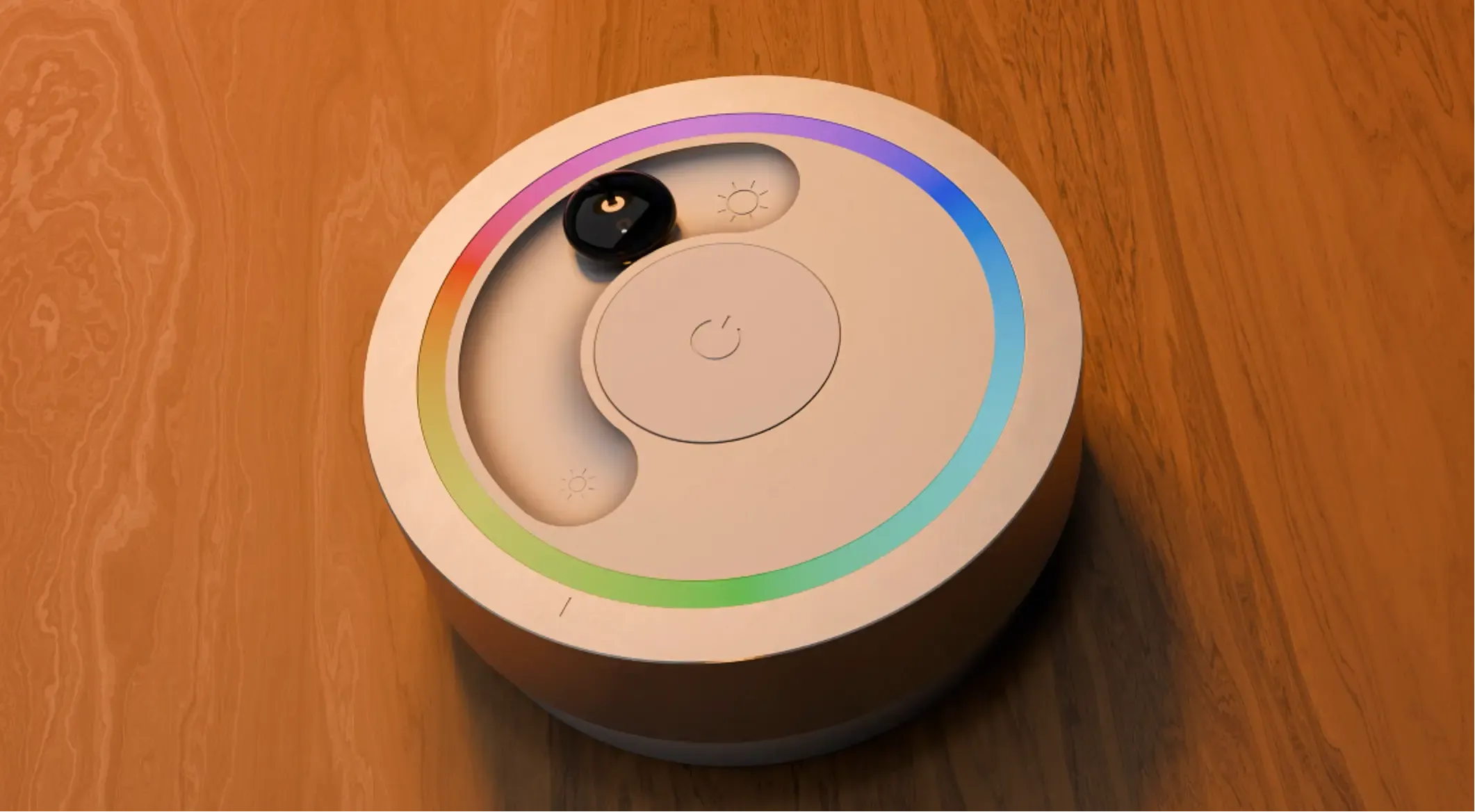 a light remote on a wooden table. The remote has a rainbow colored light ring, a marble in a slider and an on/off button.